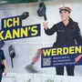 Carina Gruber in zweifacher Ausführung: auf und vor der Plakatwand in Vordernberg