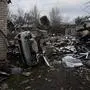 This photograph shows a destroyed car and rubble from a recent shelling in Pokrovsk, Donetsk region, on November 24, 2024. The first snow falls on Ukraine and settlements close to the front line, while Russia continues to shell energy infrastructures, promising a "very difficult winter" according to Kiev. (Photo by Florent VERGNES / AFP)