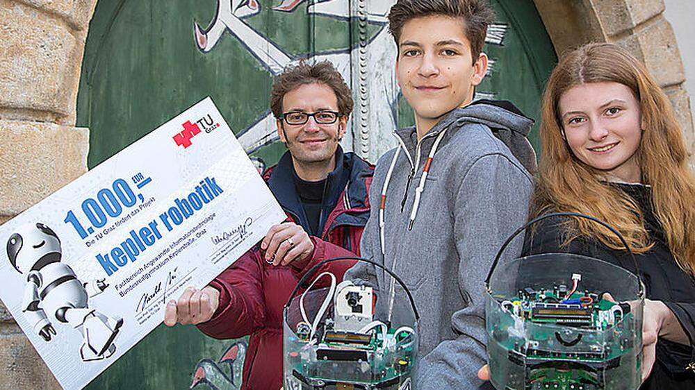 Kepler-Informatiker Leander Brandl freut sich mit Konstantin Andritsch und Désirée Rentz über den Scheck der TU Graz.