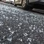 Broken rear glass of car, spread fragments of glass on asphalt