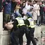 Police officers detain a fan gather in front of the National Gallery, in Trafalgar Square, London, Sunday July 11, 2021, ahead of the Euro 2020 soccer championship final match between England and Italy at Wembley Stadium. (Ian West/PA via AP)
