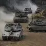 Israeli army tanks manoeuvre in a staging area in northern Israel near the Israel-Lebanon border, Tuesday, Oct. 1, 2024. (AP Photo/Baz Ratner)