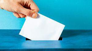 european Union parliament election concept - hand putting ballot in blue election box