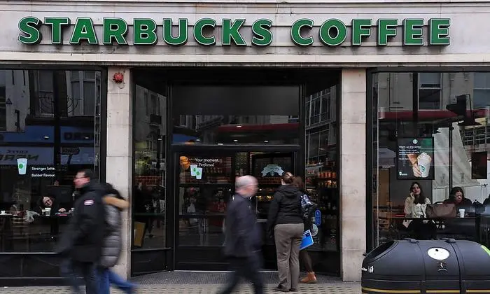 epa03559744 A Starbucks coffee chain branch in central London, Britain, 28 January 2013. Starbucks has rejected reports it has held talks with government officials over fears it was being singled out for criticism of corporate tax avoidance. Starbucks confirmed that it had had a meeting at Downing Street January 25 but indicated this had been scheduled previously. Prime Minister David Cameron recently said in a speech at Davos 'tax avoiders need to wake up and smell the coffee