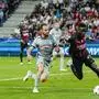 AC Milan's Divock Origi, right, duels for the balls with Salzburg's Andreas Ulmer during the Champions League group E soccer match between RB Salzburg and AC Milan at the Salzburg stadium in Salzburg, Austria, Tuesday, Sept. 6, 2022. (AP Photo/Florian Schroetter)