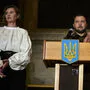 Wolodymyr Selenskyj am Redepult, links seine Frau Olena