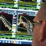 Charts on the screen of Specialist Anthony Matesic are seen through his glasses as he works on the floor of the New York Stock Exchange, Monday, April 21, 2025. (AP Photo/Richard Drew)