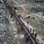 Palestinians sit at a large table surrounded by the rubble of destroyed homes and buildings as they gather for iftar, the fast-breaking meal, on the first day of Ramadan in Rafah, southern Gaza Strip, Saturday, March 1, 2025 (AP Photo/Abdel Kareem Hana)
