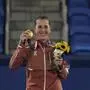 FILE - Belinda Bencic of Switzerland poses with the gold medal in the women's singles of the tennis competition at the 2020 Summer Olympics, Sunday, Aug. 1, 2021, in Tokyo, Japan. Olympic tennis champion Belinda Bencic says she is expecting her first child. The 26-year-old Swiss star and her partner Martin Hromkovic announced the news on their Instagram accounts. (AP Photo/Seth Wenig, File)