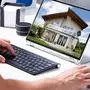 Man Selecting New House On Laptop At Home