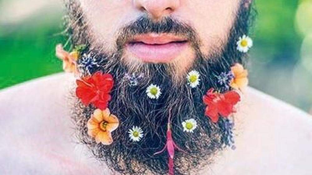 man´s face  beard flowers  beard close-up on natural background, toned