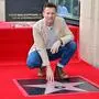 British actor Ewan McGregor touches his star during his Hollywood Walk of Fame Star ceremony in Hollywood, California, September 12, 2024. (Photo by Frederic J. BROWN / AFP)