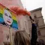A protester holds a sign depicting Hungary's Prime Minister Viktor Orban during a protest in Budapest on March 25, 2025 against the government efforts to restrict the freedom of assembly and expand its surveillance powers. Hungarian lawmakers passed legislation on March 18, 2025 aimed at banning the annual Pride march and enabling the use of facial recognition tools to identify participants of banned demonstrations. (Photo by Peter Kohalmi / AFP)