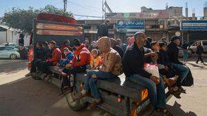 Palestinians ride in the back of a small truck as means of transportation in Rafah in the southern Gaza Strip on February 11, 2024, amid the ongoing conflict between Israel and the Palestinian militant group Hamas. (Photo by MOHAMMED ABED / AFP)