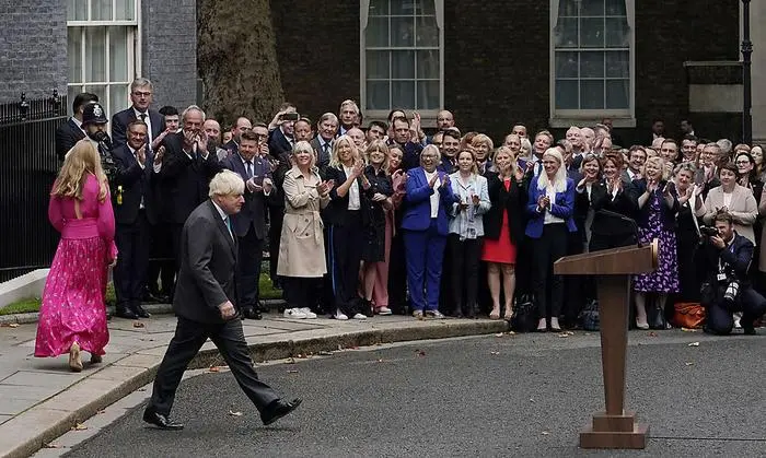 Outgoing British Prime Minister Boris Johnson arrives with his wife Carrie, left, to speak outside Downing Street in London, Tuesday, Sept. 6, 2022 before heading to Balmoral in Scotland, where he will announce his resignation to Britain's Queen Elizabeth II. Later on Tuesday Liz Truss will formally become Britain's new Prime Minister after an audience with the Queen. (AP Photo/Alberto Pezzali)