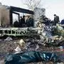 People stand near the wreckage after a Ukrainian plane carrying 176 passengers crashed near Imam Khomeini airport in Tehran on January 8, 2020. - All 176 people on board a Ukrainian passenger plane were killed when it crashed shortly after taking off from Tehran on January 8, Iranian state media reported. State news agency IRNA said 167 passengers and nine crew members were on board the aircraft operated by Ukraine International Airlines. (Photo by ROHHOLLAH VADATI / ISNA / AFP)