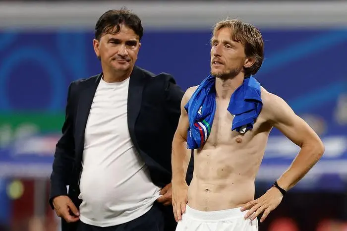 Croatia's midfielder #10 Luka Modric (R) and Croatia's head coach Zlatko Dalic (L) react at the end of the UEFA Euro 2024 Group B football match between Croatia and Italy at the Leipzig Stadium in Leipzig on June 24, 2024. (Photo by Odd ANDERSEN / AFP)
