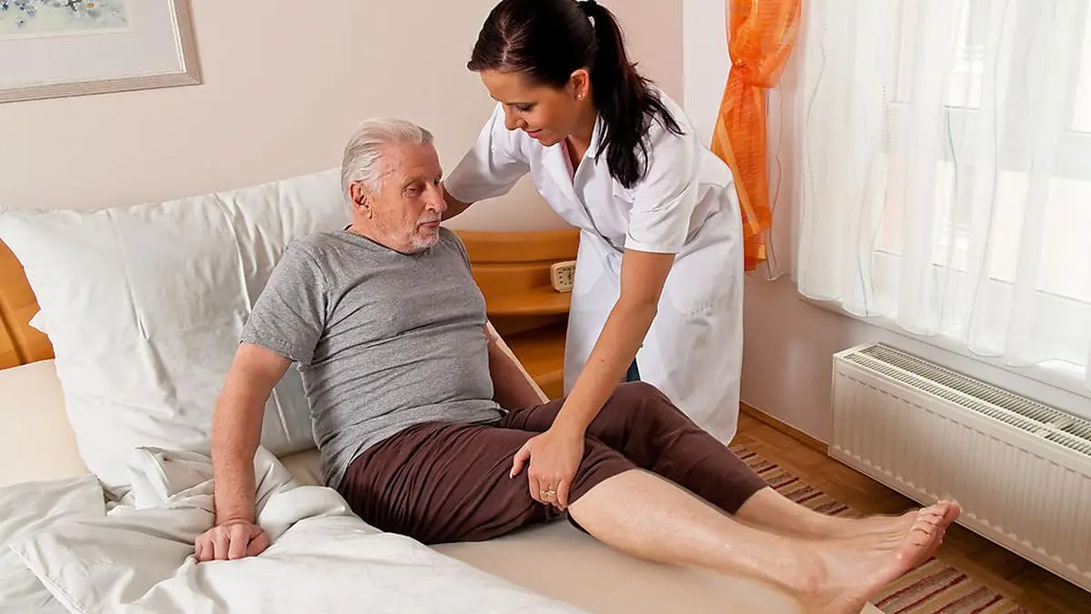 eine Pflegerin bei Altenpflege von Senioren im Altenheim