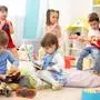 Kindergarten teacher with children on music lesson in day care. Little kids toddlers play together with developmental toys.