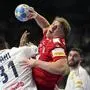 Austria's Lukas Hutecek, right, and France's Dylan Nahi challenge during the Handball European Championship main round match between France and Austria in Cologne, Germany, Monday, Jan. 22, 2024. (AP Photo/Martin Meissner)