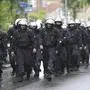 Riot police walk on the street ahead the Group C match between Serbia and England at the Euro 2024 soccer tournament in Gelsenkirchen, Germany, Sunday, June 16, 2024. (AP Photo/Markus Schreiber)