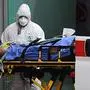 Medical workers stretch a patient from an Italian Red Cross ambulance into an intensive care unit set up in a sports center outside the San Raffaele hospital in Milan, on March 23, 2020 during the COVID-19 new coronavirus pandemic. (Photo by Miguel MEDINA / AFP)