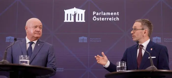 The leader of the far-right Freedom party (FPOe) Herbert Kickl (R) and Austrian People's Party (OeVP) interim leader Christian Stocker address a press conference on coalition negotiations in the Parliament in Vienna, on January 13, 2025. Austria's president on January 6 tasked far-right leader Herbert Kickl with trying to form a government, in a historic move after coalition talks to forge a government without the Freedom party (FPOe) collapsed. (Photo by Alex HALADA / AFP)