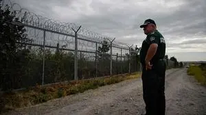 A Bulgarian border police officer patrols near the wall fence on the Bulgaria-Turkey border near the village of Kapitan Andreevo, Bulgaria on October 10, 2023, during the visit Austria's National Council chairman in Bulgaria. (Photo by Nikolay DOYCHINOV / AFP)
