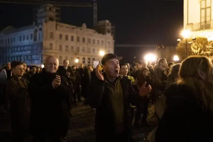 People cheer in front of Sandor Palace, office of the Hungarian President in Budapest, Saturday, Feb. 10, 2024. Hungary’s conservative president Katalin Novák has resigned amid public outcry over a pardon she granted to a man convicted as an accomplice in a child sexual abuse case, a decision that unleashed an unprecedented political scandal for the long-serving nationalist government. (AP Photo/Denes Erdos)