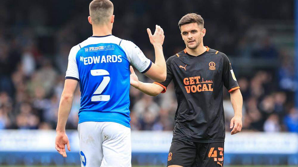 Sky Bet Championship Peterborough v Blackpool Jake Daniels 43 of Blackpool shakes pads with Ronnie Edwards 2 of Peterbo