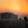 TOPSHOT - This photograph shows the Parthenon temple atop the Acropolis hill in a smoke cloud from a wildfire, in Athens on August 12, 2024. On August 12, 2024, Greece's civil protection authorities ordered the evacuation of several towns in the north-eastern suburbs of Athens, threatened by a violent fire that started the day before and is spreading. (Photo by Angelos TZORTZINIS / AFP)