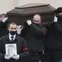 Workers carry the coffin and a portrait of Russian opposition leader Alexei Navalny out of the Church of the Icon of the Mother of God Soothe My Sorrows, in Moscow, Russia, Friday, March 1, 2024. Relatives and supporters of Alexei Navalny are bidding farewell to the opposition leader at a funeral in southeastern Moscow, following a battle with authorities over the release of his body after his still-unexplained death in an Arctic penal colony. (AP Photo)