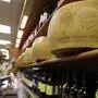 Wheels of parmesan cheese are stored in a deli in Rome, Thursday, Oct. 3, 2019. The U.S. had prepared for Wednesday's ruling and already drawn up lists of the dozens of goods it would put tariffs on. They include EU cheeses, olives, and whiskey, as well as planes, helicopters and aircraft parts in the case _ though the decision is likely to require fine-tuning of that list if the Trump administration agrees to go for the tariffs. (AP Photo/Alessandra Tarantino)