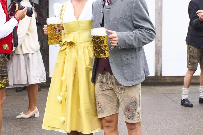 Joshua Kimmich ließ sich das Oktoberfest nicht entgehen. Hier mit seiner Frau Lina Meyer, sie hat sich für ein auffälliges gelbes Dirndl entschieden.