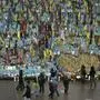 People walk past the memorial to fallen soldiers in Independence Square in Kyiv, Ukraine, Friday, Nov. 15, 2024. (AP Photo/Efrem Lukatsky)