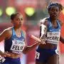 USA's Jessica Beard (R) hands over to Allyson Felix in the Women's 4x400m Relay heats at the 2019 IAAF Athletics World Championships at the Khalifa International stadium in Doha on October 5, 2019. (Photo by KARIM JAAFAR / AFP)