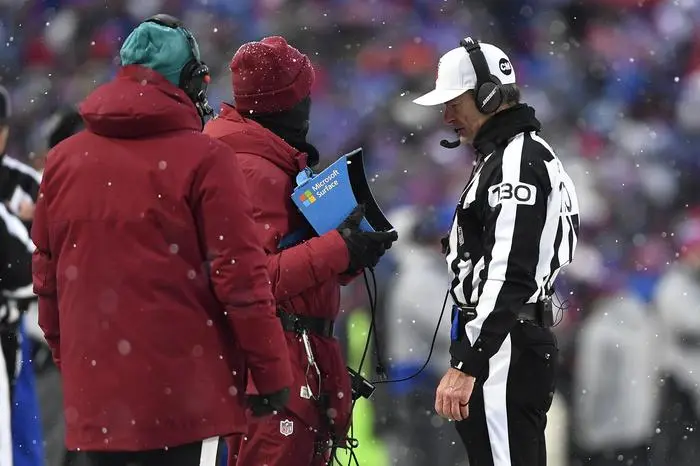 FILE - Referee Land Clark reviews a play during the second half of an NFL football game between the Buffalo Bills and the Atlanta Falcons in Orchard Park, N.Y.,  Jan. 2, 2022. The Indianapolis Colts are proposing a rule change that would allow for challenges of penalty calls in the last two minutes of the half. The NFL released a list of several rule change proposals Wednesday, March 13, made by teams. (AP Photo/Adrian Kraus, File)