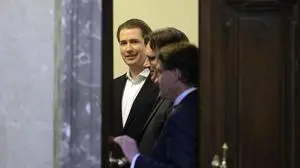 Former Austrian Chancellor Sebastian Kurz, left, waits to appear at court on the first day of his trial in Vienna, Austria, Wednesday, Oct. 18, 2023. Kurz is charged with having allegedly making false statements to a parliamentary inquiry into alleged corruption in his first government. (AP Photo/Heinz-Peter Bader)
