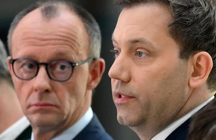 (FILES) The leader of Germany's Christian Democratic Union (CDU) party Friedrich Merz (L) looks on as the co-leader of Germany's social democratic SPD party Lars Klingbeil speaks during a joint statement in Berlin on March 8, 2025, as exploratory talks were held between the conservative CDU/CSU union and the social democratic SPD party on forming a future government coalition following Germany's February 23 general election. The co-leader of Germany's Social Democrats (SPD) Lars Klingbeil will be the next finance minister and vice chancellor under the incoming conservative chancellor, Friedrich Merz, a party source said on April 30, 2025. The SPD party leadership unanimously approved Klingbeil's nomination, which came shortly after the party announced its members had overwhelmingly approved a coalition agreement with Merz's CDU/CSU alliance. (Photo by RALF HIRSCHBERGER / AFP)