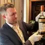 (FILES) A member of staff shows a bottle of the Macallan Valerio Adami 60 Year Old 42.8 abv 1926, the world's most valuable whisky estimated between 750,000 - 1,200,000 £ (860,800 - 1,377,300 €), during a photocall at the auction house Sotheby's in London, on October 19, 2023. A bottle of The Macallan 1926, described by Sotheby's auction house as the "most valuable whisky in the world" went under the hammer for a record £2.1 million on November 18, 2023. The sale set a "new record for any bottle of spirit or wine sold at auction", Sotheby's told AFP. (Photo by Mathilde BELLENGER / AFP)
