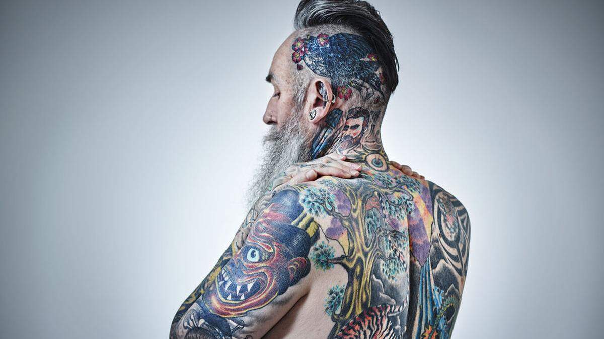 Heavily tattooed mature male