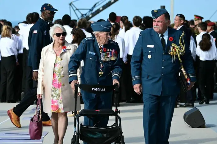 Canadian Air Force Major-General Richard H. Rohmer (C) attends the International commemorative ceremony at Omaha Beach marking the 80th anniversary of the World War II "D-Day" Allied landings in Normandy, in Saint-Laurent-sur-Mer, in northwestern France, on June 6, 2024. The D-Day ceremonies on June 6 this year mark the 80th anniversary since the launch of 'Operation Overlord', a vast military operation by Allied forces in Normandy, which turned the tide of World War II, eventually leading to the liberation of occupied France and the end of the war against Nazi Germany. (Photo by MIGUEL MEDINA / AFP)