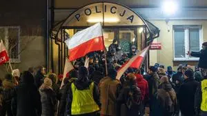 People wave Polish flags during a rally in front of the police station where Wasik and Kaminski are staying, in Warsaw, January 9, 2024. About a hundred people gathered to express support for MPs Maciej Wasik and Mariusz Kaminski, who were sentenced to prison by the court. Both parliamentarians were arrested this evening at the Presidential Palace. Warsaw Poland Rally in support of PiS MP s in Warsaw 2024/01/09 Copyright: xMarekxAntonixIwanczukx MAI09569-Enhanced-NR