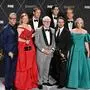 Cast members from "Succesion" (from L) US actor Alan Ruck, Australian actress Sarah Snook, Swedish actor Alexander Skarsgard, Scottish actor Brian Cox, US actor Nicholas Braun, US actor Kieran Culkin, British actor Matthew Macfadyen and US actress J. Smith-Cameron pose in the press room with the award for Outstanding Drama Series during the 75th Emmy Awards at the Peacock Theatre at L.A. Live in Los Angeles on January 15, 2024. (Photo by Robyn BECK / AFP)