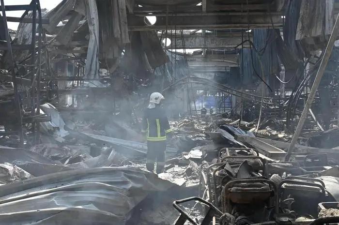 An employees of the State Emergency Service of Ukraine stands in the middle of debris in a hardware supermarket in Kharkiv destroyed by a Russian strike, on May 26, 2024, amid the Russian invasion in Ukraine. The death toll from a Russian strike on a hardware superstore in the eastern Ukrainian city of Kharkiv rose to 12 Sunday, the interior minister said, with President Volodymyr Zelensky condemning the attack as 