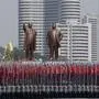 In this Saturday, April 15, 2017 photo, university students carry North Korean national flags and two bronze statues of the late leaders Kim Il Sung and Kim Jong Il during a military parade in Pyongyang, North Korea, to celebrate the 105th birth anniversary of Kim Il Sung, the country's late founder and grandfather of current ruler Kim Jong Un. (AP Photo/Wong Maye-E, File)