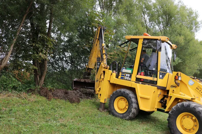 Die Bauhofmitarbeiter beseitigen den Schlamm aus dem Bach um Überschwemmungen vorzubeugen.