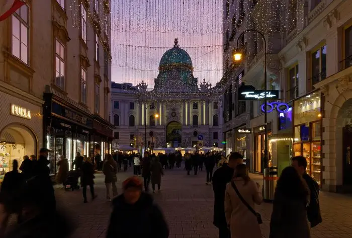 VIENNA, Austria - January 6, 2023: Kohlmarkt, pedestrian luxury shopping street just outside Hofburg palace, crowded with people in the evening