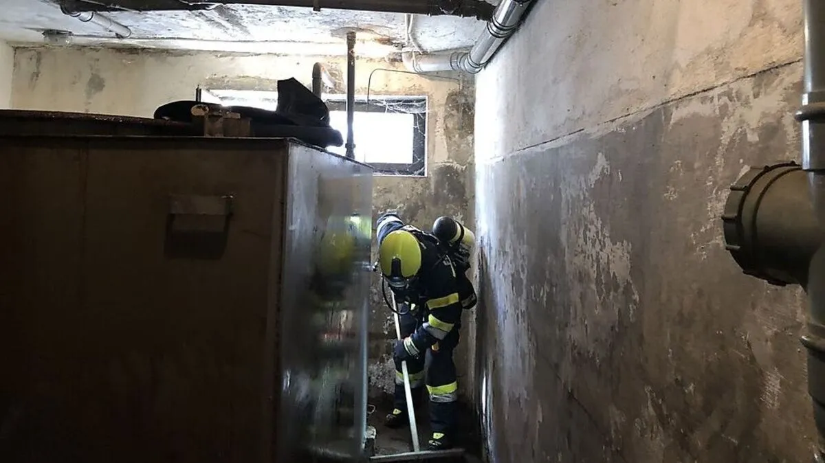 Mit schwerem Atemschutz arbeiten die Feuerwehrleute im Keller