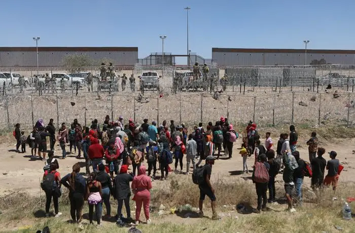 Migrant people seeking asylum in the United States demonstrate on the Rio Grande river to ask for authorization to enter the country, as seen from Ciudad Juarez, state of Chihuahua, Mexico on April 25, 2024. (Photo by Herika Martinez / AFP)